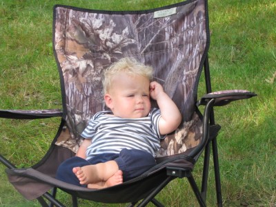 Zion lounging in an adult-size camping chair