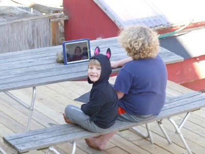 Harvey and Lijah on a Zoom call on the iPad on the back deck