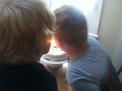 Harvey blowing out the candles on the cake at Grandma Judy's
