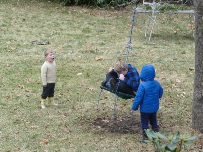 the boys playing on and around the swing in our yard