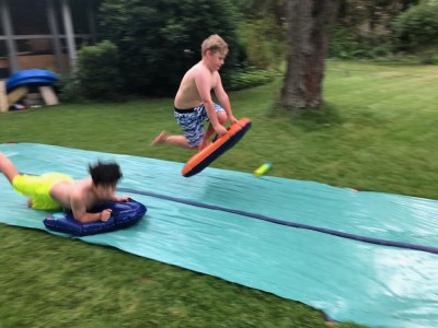 Zion airborne jumping onto the slip-and-slide