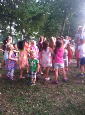 Lijah, still, surrounded by kids trying to catch bubbles