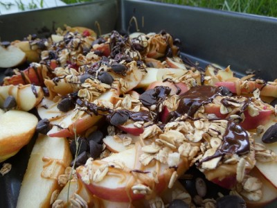 apple slices covered with melted chocolate and peanut butter and chocolate chips