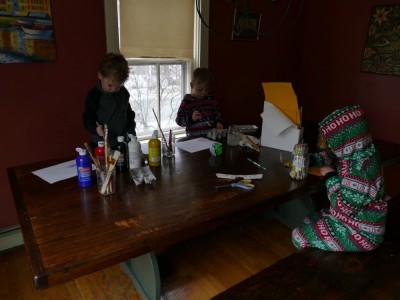 the boys concentrating on art at the kitchen table
