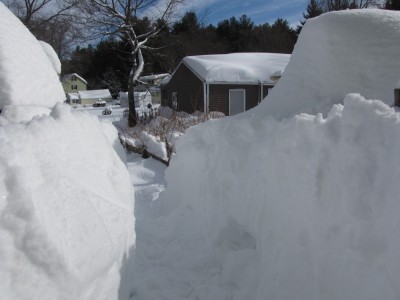 a cut through deep snow on the back porch