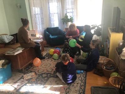 kids listening to a story surrounded by balloons