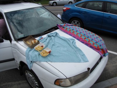 towels and fried food on the hood of the car