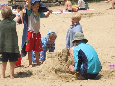 the boys watch friends at work on a sand castle