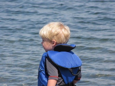 Zion in his life jacket by the water