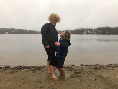 Harvey and Zion with their feet in a puddle on the beach at Freeman Lake