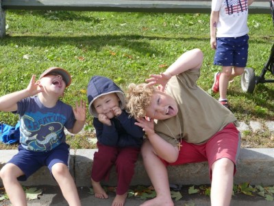the boys sitting on the curb making silly faces