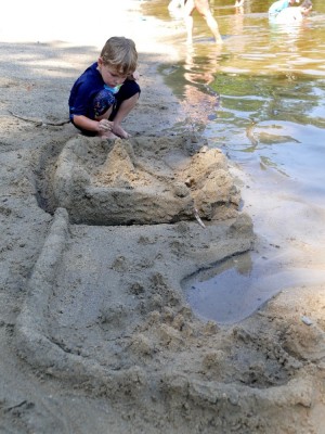 Lijah putting the finishing touches on a big sand city