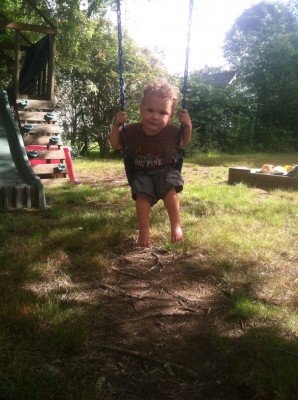 Lijah swinging on the neighbors' swing