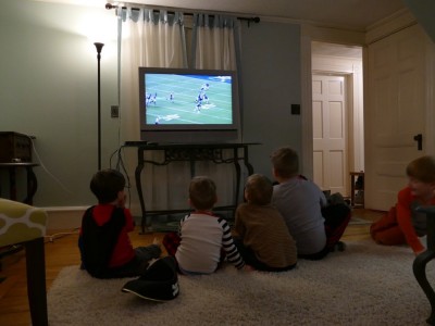 the boys watching football with friends