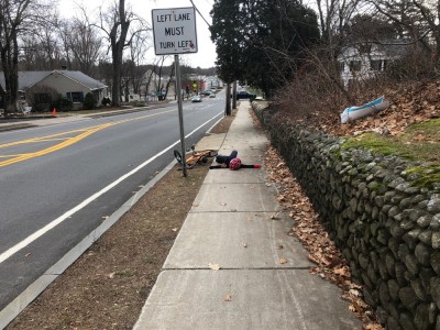 Elijah lying on the ground next to his fallen bike