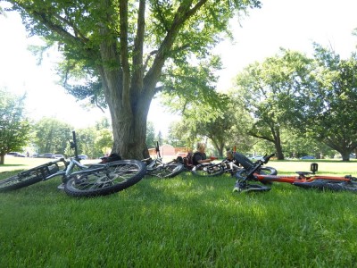 boys reclining on grass with bikes