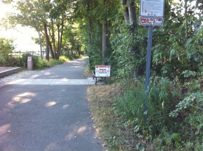 a sign by the bike path