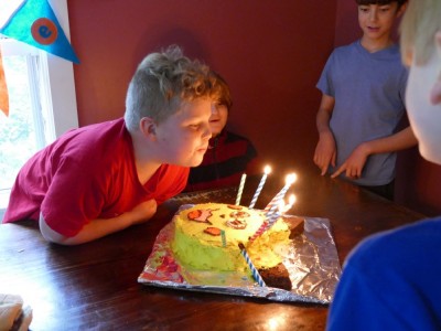 Harvey blowing out the candles on his Pikachu cake