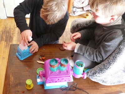 Elijah and Zion playing with his new birthday playdoh candy factory