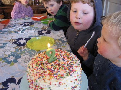 Lijah and Harvey getting ready to blow out the birthday candle