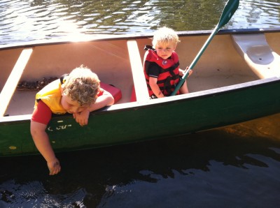 Zion and Harvey in a canoe on the river