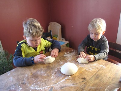Harvey and Zion shaping their loaves at the kitchen table