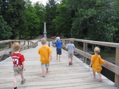 boys and friends walking across the Old North Bridge