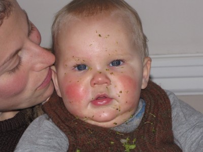 Lijah with broccoli bits all over his face
