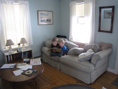 Harvey reading to Lijah on the couch