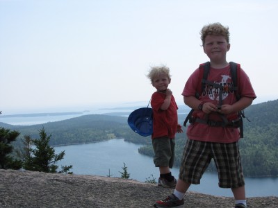 Zion and Harvey atop North Bubble, with Jordan Pond and the Atlantic Ocean behind them