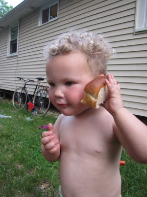 Lijah holding a hot dog bun like it's a telephone