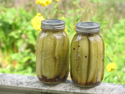 two quarts of pickles on the porch railing