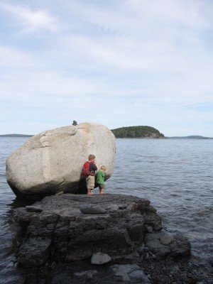 Harvey and Zion checking out a big big rock on the shore