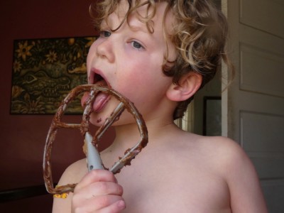 Elijah licking chocolate cake batter from the beater