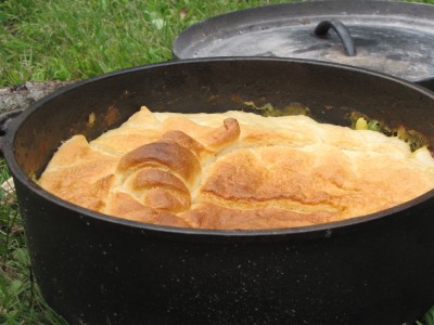 a pot pie in a dutch oven on the grass