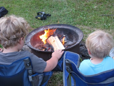 Harvey and Zion sitting in their chairs at the campfire