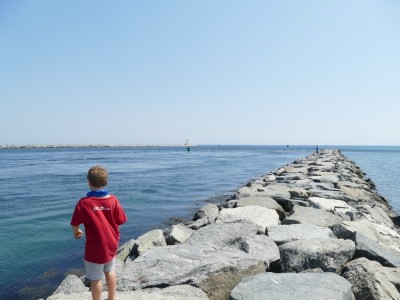 Zion standing on a breakwater looking at the Canal