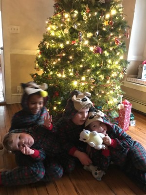 the boys with their cousin in front of Grandma and Grandpa's tree