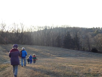 boys and grandparents walking in a field