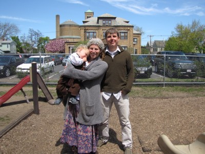 Mama, Dada, and Zion posing on the church playground