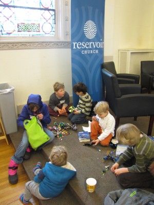 the boys and friends playing with lots of legos at church