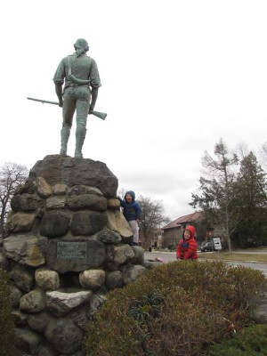 Zion and Harvey climbing Lexington's Minuteman statue