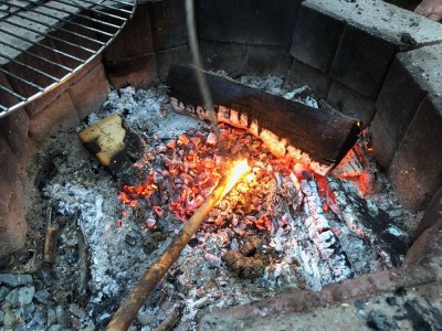 sticks prodding the coals in the fireplace