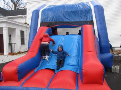 Harvey and Zion on the slide of a giant bounce house