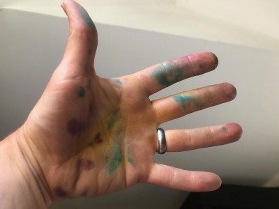 my hand spotted with different splotches of food coloring