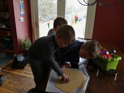 the boys cutting out sugar cookies at the kitchen table