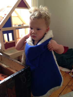 Lijah wearing a king cape over his front (and nothing else)