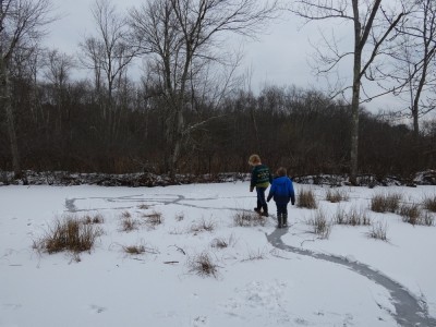 Harvey and Zion walking on a twisty shoveled path on the ice