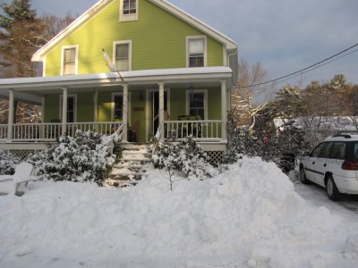 the front of the house with snow
