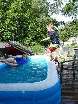 Elijah jumping into the pool, Harvey watching